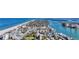 Scenic aerial view showcasing a coastal town with a beautiful beach and waterfront properties at 521 Mandalay Ave # 307, Clearwater Beach, FL 33767