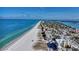 Wide aerial view of a beachside town with long sandy beaches and various types of real estate buildings at 521 Mandalay Ave # 307, Clearwater Beach, FL 33767