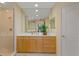 Bathroom features a long vanity with wood cabinets and a glass enclosed shower at 521 Mandalay Ave # 307, Clearwater Beach, FL 33767