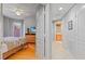 Bedroom with hardwood flooring, ceiling fan, and view into the Primary bathroom at 521 Mandalay Ave # 307, Clearwater Beach, FL 33767