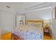 Bedroom with a tropical themed bedspread, and laundry area at 521 Mandalay Ave # 307, Clearwater Beach, FL 33767