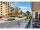 Beautiful courtyard entrance featuring lush landscaping, mature palms, and circular drive at 521 Mandalay Ave # 307, Clearwater Beach, FL 33767