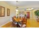 Spacious dining room featuring hardwood floors and a wooden table set for six at 521 Mandalay Ave # 307, Clearwater Beach, FL 33767