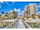 Scenic view of beachfront condos, pool, and palm trees with waterfront access at 521 Mandalay Ave # 307, Clearwater Beach, FL 33767
