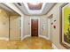 Inviting hallway with neutral tones, travertine flooring, and decorative ceiling features at 521 Mandalay Ave # 307, Clearwater Beach, FL 33767