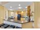 Bright eat-in kitchen featuring natural wood cabinetry, black appliances, and bar top with seating at 521 Mandalay Ave # 307, Clearwater Beach, FL 33767