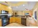 Open-concept kitchen featuring breakfast bar, stainless appliances, and seamless flow to living area at 521 Mandalay Ave # 307, Clearwater Beach, FL 33767