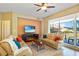 Cozy living room featuring comfortable seating, modern entertainment setup, and a balcony at 521 Mandalay Ave # 307, Clearwater Beach, FL 33767
