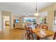 Open-concept living space with hardwood floors, dining area, and access to a balcony with ocean views at 521 Mandalay Ave # 307, Clearwater Beach, FL 33767