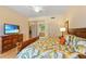 Comfortable main bedroom with a television, an attached bathroom, and tropical style at 521 Mandalay Ave # 307, Clearwater Beach, FL 33767