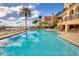 Beautiful community pool with an abundance of lounge chairs to relax by the water at 521 Mandalay Ave # 307, Clearwater Beach, FL 33767