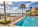 Community pool and boat docks featuring plenty of lounge chairs at 521 Mandalay Ave # 307, Clearwater Beach, FL 33767