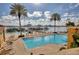 Community pool with lounge chairs and views of the marina at 521 Mandalay Ave # 307, Clearwater Beach, FL 33767