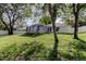 Spacious backyard featuring a screened-in patio and a white privacy fence at 5435 Birchwood Rd, Spring Hill, FL 34608