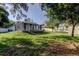 Large backyard with a screened-in patio, perfect for outdoor relaxation and entertainment at 5435 Birchwood Rd, Spring Hill, FL 34608