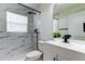 Bathroom with a shower, toilet, and white vanity with black faucet and fixtures at 5435 Birchwood Rd, Spring Hill, FL 34608