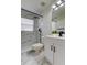 Bathroom with a marble style shower and white vanity with black fixtures at 5435 Birchwood Rd, Spring Hill, FL 34608