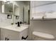 Bathroom with white vanity, black fixtures, and decorative plants near the window at 5435 Birchwood Rd, Spring Hill, FL 34608