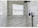 Marble-style shower stall with window and black fixtures at 5435 Birchwood Rd, Spring Hill, FL 34608