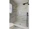 Bathroom with shower that has white marble-like tile, and a black shower head and fixtures at 5435 Birchwood Rd, Spring Hill, FL 34608