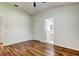 Bedroom features wood floors, a ceiling fan and an attached bathroom at 5435 Birchwood Rd, Spring Hill, FL 34608