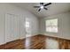 Bedroom features wood floors, a ceiling fan and an attached bathroom at 5435 Birchwood Rd, Spring Hill, FL 34608