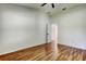 Bedroom features wood floors, a ceiling fan and an entrance at 5435 Birchwood Rd, Spring Hill, FL 34608