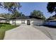 Charming single-story home featuring a spacious driveway, manicured lawn, and an attached two-car garage at 5435 Birchwood Rd, Spring Hill, FL 34608