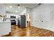 Modern kitchen with stainless steel appliances, white cabinets, quartz countertops, and wood-look flooring at 5435 Birchwood Rd, Spring Hill, FL 34608