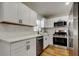 Updated kitchen with stainless steel appliances, white cabinets, and quartz countertops at 5435 Birchwood Rd, Spring Hill, FL 34608