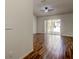Spacious living room featuring wood-look tile flooring and a sliding glass door leading to the pool area at 5435 Birchwood Rd, Spring Hill, FL 34608