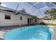 Backyard view of the inviting screened-in pool, accessible directly from the home's patio at 5435 Birchwood Rd, Spring Hill, FL 34608