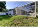 Backyard featuring screened-in pool, white privacy fence, and exterior of home at 5435 Birchwood Rd, Spring Hill, FL 34608