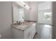 Bathroom with double vanity, granite countertop, and view into bedroom at 5530 N 9Th St # 6, Tampa, FL 33604