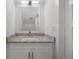 Bathroom featuring a vanity with granite countertop, contemporary mirror, and modern lighting at 5530 N 9Th St # 6, Tampa, FL 33604