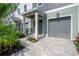 Charming townhome boasting a private garage, paver driveway and manicured front yard at 5530 N 9Th St # 6, Tampa, FL 33604