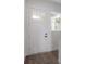 Bright white front door with sidelight and wood flooring at 5530 N 9Th St # 6, Tampa, FL 33604