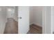 Bright hallway featuring white doors and trim complemented by modern flooring extends toward the entryway at 5530 N 9Th St # 6, Tampa, FL 33604