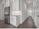 Hallway leading to the front door displays modern flooring and neutral walls complemented by white trim at 5530 N 9Th St # 6, Tampa, FL 33604