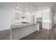 Bright modern kitchen with white cabinetry, stainless steel appliances, and a stylish island featuring marble countertops at 5530 N 9Th St # 6, Tampa, FL 33604