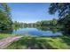 Scenic view of the lake, surrounded by lush greenery and mature trees on a sunny day at 5530 N 9Th St # 6, Tampa, FL 33604