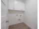 Compact laundry room with modern white cabinets and fixtures at 5530 N 9Th St # 6, Tampa, FL 33604