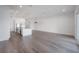 Bright living room with light wood floors and a view of the modern white kitchen at 5530 N 9Th St # 6, Tampa, FL 33604