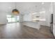 Open floor plan shows the bright living spaces with sleek floors and a modern kitchen with an island at 5530 N 9Th St # 6, Tampa, FL 33604