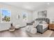 A calming bedroom with two windows, plush seating, and warm hardwood flooring at 5530 N 9Th St # 6, Tampa, FL 33604