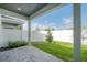 Private backyard featuring a paved patio, green lawn, and white fencing at 5530 N 9Th St # 6, Tampa, FL 33604