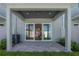 Covered outdoor patio with pavers, view of interior living space through sliding glass doors and fenced-in yard at 5530 N 9Th St # 6, Tampa, FL 33604