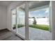 Sliding glass doors open to a paved patio and fenced backyard at 5530 N 9Th St # 6, Tampa, FL 33604