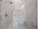 Elegant marble tiled shower with glass door and chrome shower head at 5530 N 9Th St # 6, Tampa, FL 33604