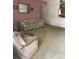 Large living room with large floral couch and a plush armchair at 5680 24Th N Ave, St Petersburg, FL 33710